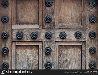 Old wooden door with steel lock and decoration build in concrete building
