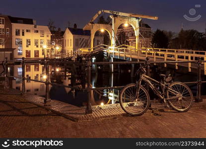 Old wooden drawbridge at night. Leiden. Netherlands.. Old drawbridge over the canal in Leiden at dawn.