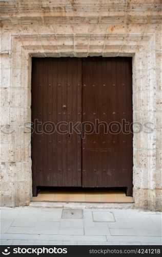 "Old wooden entrance door in Valladolid, "Castilla y Leon", Spain."