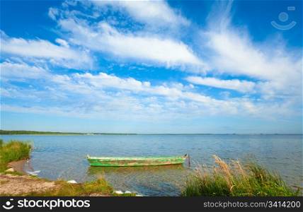 Old wooden fishing boat on summer lake bank (Svityaz, Ukraine)