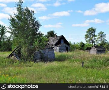 Old wooden house abandoned in the grassland
