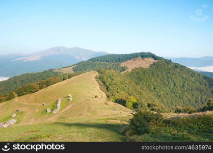 Old wooden house in a mountain valley. Autumn Carpathians landscape in the morning.