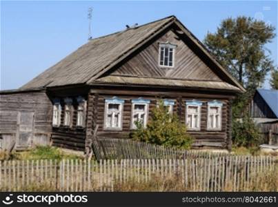 Old wooden house in the village, sunny summer day