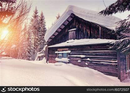 old wooden house in winter landscape photo