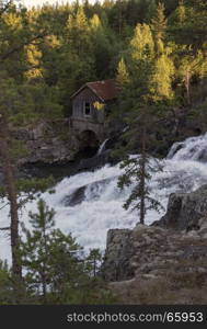 old wooden house near waterfall in norway near the jotunheimen national park at leira village