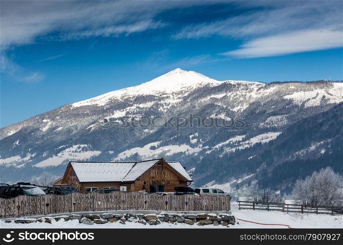 Old wooden house on snowy high mountain in Austrian Alps