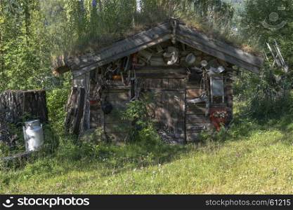 old wooden house with a lot of zink equipment like pots,pans and other