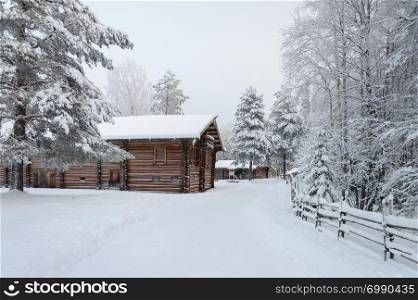 "Old wooden houses in Northern Russian village. Tourist complex "Malye Korely", winter time."