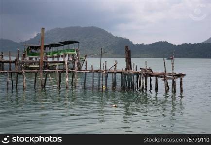 Old wooden jetty on exotic beach of a tropical island Koh Chang,Thailand