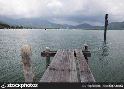 Old wooden jetty on exotic beach of a tropical island Koh Chang,Thailand