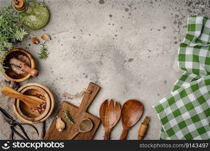 Old wooden kitchen utensils or cooking tools and bowls on gray background, top view, flat lay. Kitchenware collection with copy space. Cooking background.. kitchen utensils or cooking tools