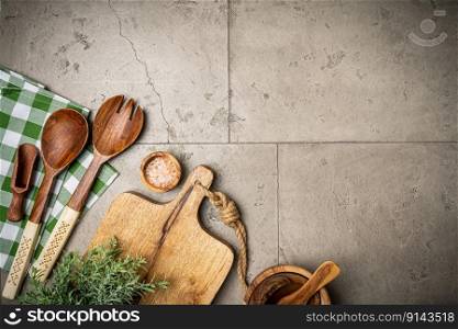 Old wooden kitchen utensils or cooking tools on gray stone background, top view, flat lay. Kitchenware collection with copy space. Cooking background.. kitchen utensils or cooking tools