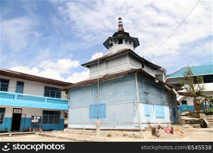 Old wooden mosque near houses in Maninjau, Indonesia