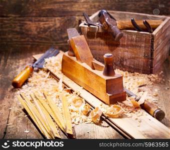 old wooden plane with various tools in a workshop