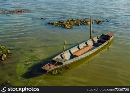 old wooden rowboat floating on water