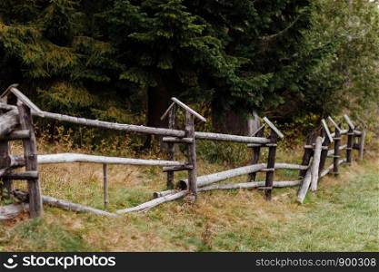 old wooden rural fence in the mountains of a beautiful autumn day. Beautiful landscape. old wooden rural fence in the mountains of a beautiful autumn day