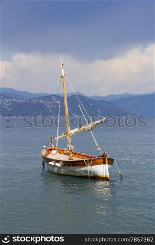 Old wooden sail ship, docked in the port of Portofino, Italy