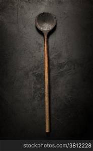 old wooden spoon on dark background