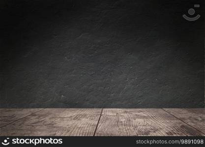 Old wooden table top  in the dark wall background.