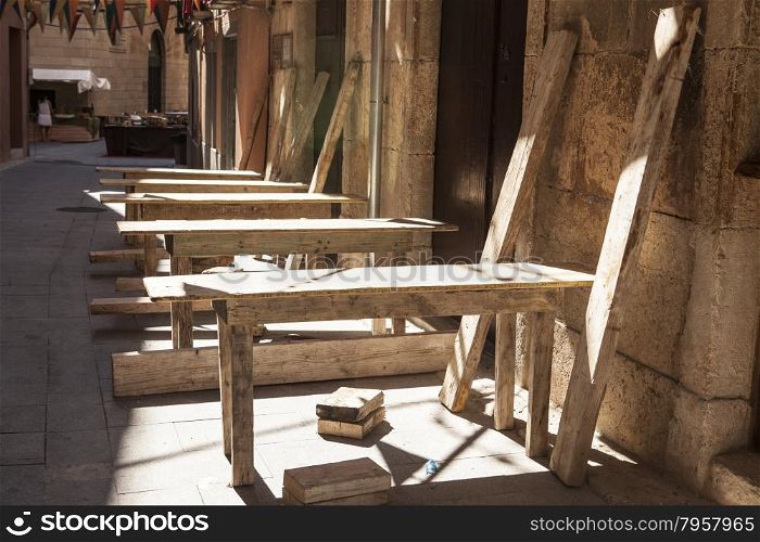 Old wooden tables at an outdoor cafe .. Old wooden tables at an outdoor cafe in Spain