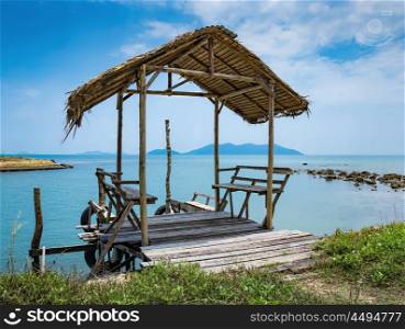 Old wooden terrace on the shore of a tropical beach