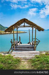 Old wooden terrace on the shore of a tropical beach