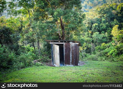 Old wooden toilet forest with zinc roof on mountains in a village hill - Outhouse toilet cabins