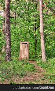 Old wooden toilet in the pine forest