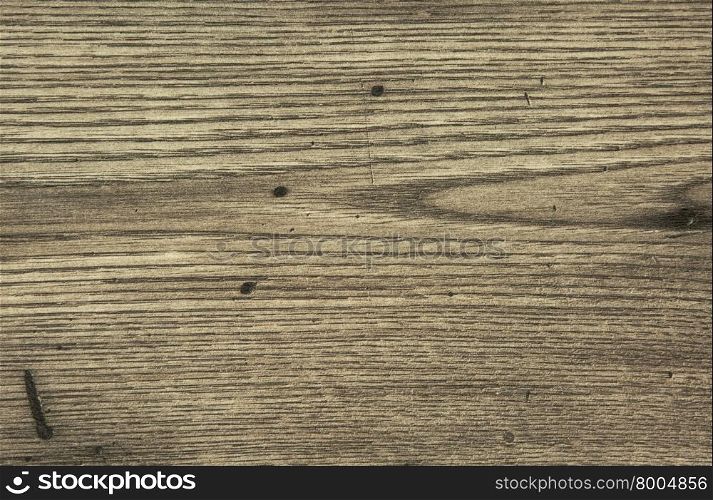 Old wooden top with visible grain and minor scratches in gray with clearly visible grain, scratches and spots. Interesting background and texture. Horizontal view.
