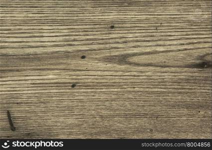 Old wooden top with visible grain and minor scratches in gray with clearly visible grain, scratches and spots. Interesting background and texture. Horizontal view.