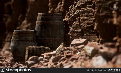 old wooden vintage wine barrels near stone wall in canyon