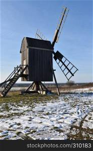Old wooden windmill at the island Oland in Sweden by winter season