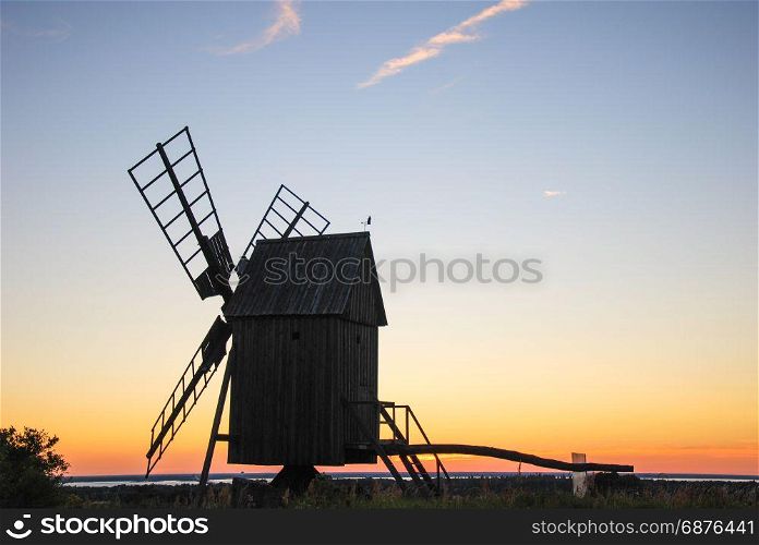 Old wooden windmill by sunset at the swedish island Oland