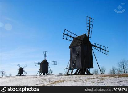 Old wooden windmills in a row at the swedish island Oland. Windmill are iconic symbols for the island Oland, the island of sun and wind