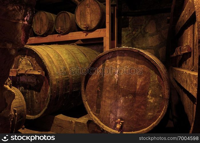 Old wooden wine barrels in cellar