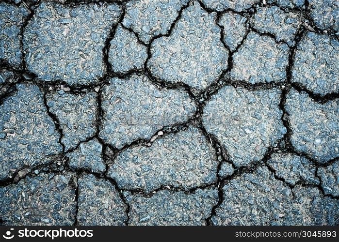 Old worn and cracked asphalt with cracks