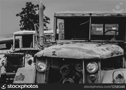 Old wrecked white and green truck. Abandoned rusty military truck. Decayed abandoned truck. Tragedy and loss. Financial crunch and economic recession concept. Old decayed lorries. Transportation.