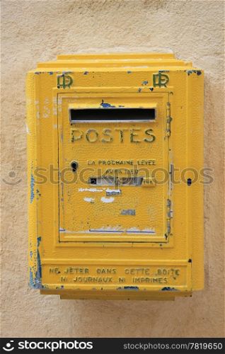 Old yellow mailbox in France, postal service