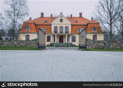 Old yellow manor at Latvia, city Liepupe. 2016