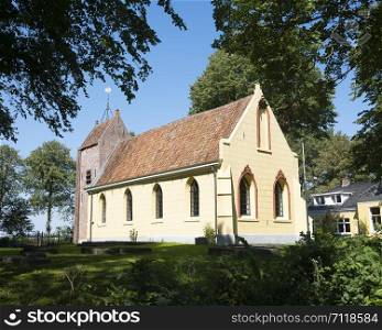 old yellow painted church of westernieland in the north of dutch province groningen