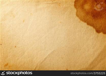 Old yellowed paper with brown stain on the corner for background