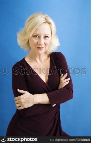 Older blonde woman with arms crossed