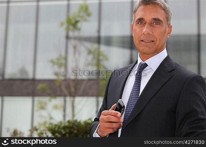 Older businessman using a cellphone