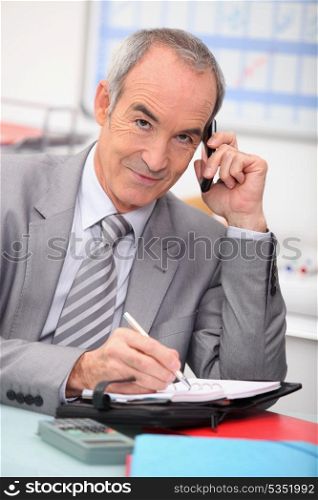 Older businessman using a cellphone