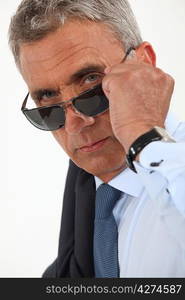 Older businessman wearing sunglasses