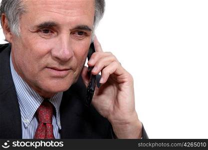 Older businessman with a cellphone