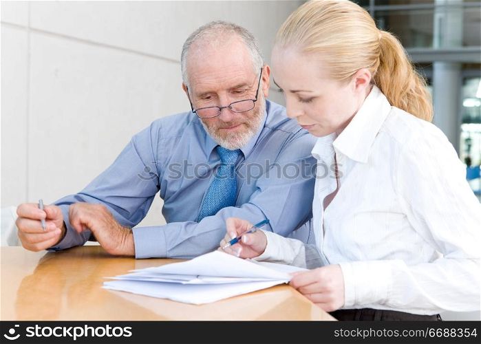older businessman with female assistant