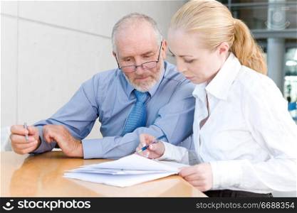 older businessman with female assistant