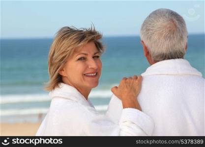 Older couple outdoors in bathrobes
