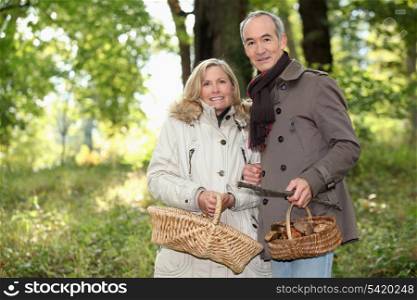 Older couple picking mushrooms